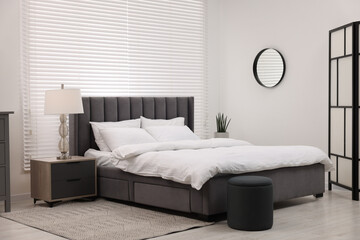 Sticker - Stylish bedroom interior with large bed and lamp