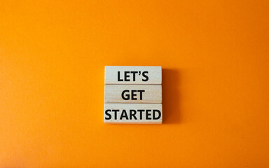 Wall Mural - lets get started symbol. concept words lets get started on wooden blocks. beautiful orange backgroun