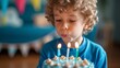 A birthday boy blowing out candles, making a special wish