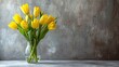 A bouquet of yellow tulips in a vase on the floor, radiating freshness and elegance