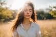 © progressman - A young woman in a field of sunshine