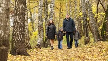 Father With Two Sons And One Daughter Walks In Autumn Forest, Slow Motion