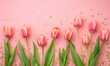 delicate pink tulips arranged in a neat row on a gradient pink with sparkling golden glitters  background,flat lay with copy space 