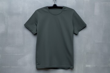 Navy Blue t shirt is seen against a gray wall