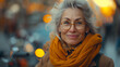 © Inga Bulgakova - Elderly beautiful smiling woman dressed in orange scarf and coat and with glasses on transparent background.  Selective focus. Copy space. Happiness concept