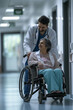 © S photographer - Caucasian doctor talking with senior patient in wheelchair in hospital.