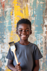 Wall Mural - Happy young African American boy confidently holding a painting brush during home renovation