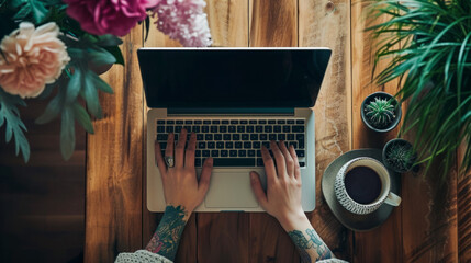 Canvas Print - A person typing on a laptop on a wooden table