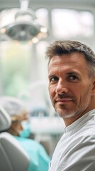 Poster - A man sitting in a chair in a dentist's office