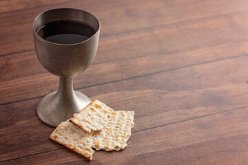 Wall Mural - Holy Communion in a Pewter Goblet with an Antique Bible on a Wooden Table