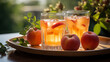 Glass with fresh fruit juice on the table and plate with ripe fruits, blossoming apple tree branch on background
