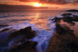 © ADDICTIVE STOCK - Sunset over rugged coastline with crashing waves