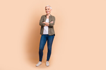 Poster - Full body photo of attractive retired woman crossed hands confident manager wear trendy khaki clothes isolated on beige color background