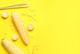 Fototapeta Mapy - Fresh corn cobs and seeds on yellow background