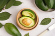 canvas print picture - Bowls with fresh ripe avocados on white background