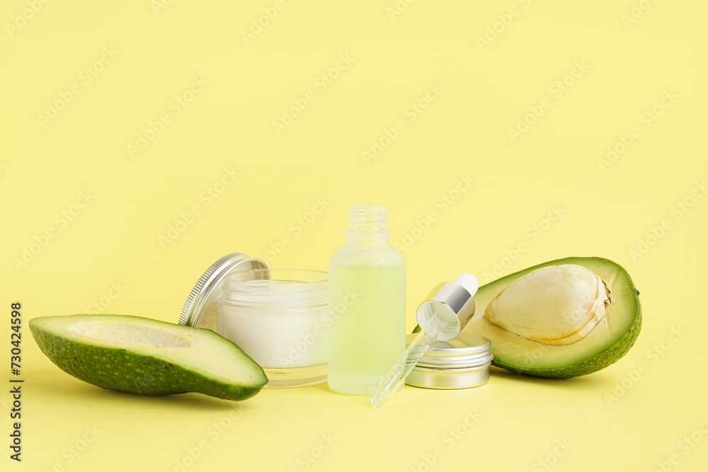 Composition with cosmetic products and ripe avocado on color background