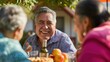 Cheerful latino or hispanic mexican man talking to his female neighbours outside on sunny day smiling with toothy smile