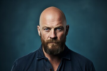 Poster - Portrait of a bald man with a long beard and mustache in a blue shirt