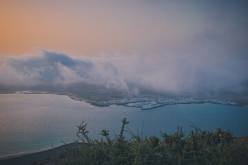 Wall Mural - Low clouds above La Graciosa island during the sunset, Lanzarote