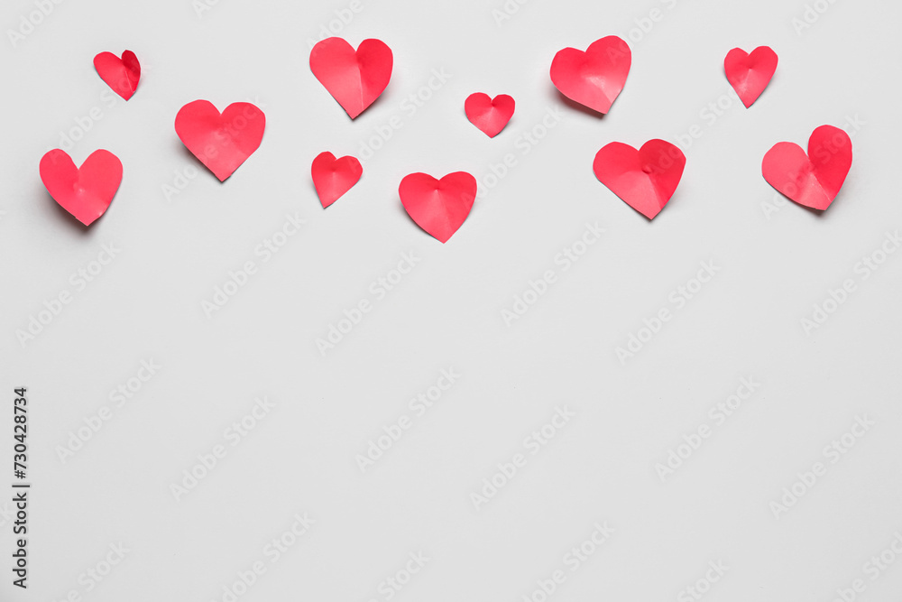 Composition with red paper hearts on grey background. Valentines Day celebration