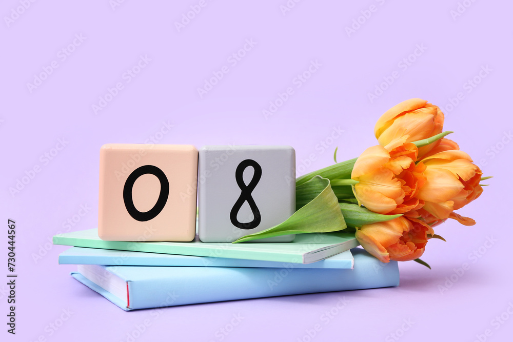 Cube calendar with date 08, beautiful orange tulips and notebooks on lilac background. International Women's Day