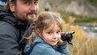 © Barbara Taylor - close up of a young girl and father taking pictures of wildlife in alaska
