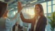 © akarawit - Businesswoman giving a high five to the colleague in meeting room