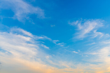 Twilight blue bright and orange yellow dramatic sunset sky in countryside or beach colorful cloudscape texture with white clouds air background.