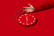 © ADDICTIVE STOCK - Conceptual image of arm wired to clock on red background
