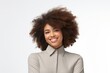 © Surachetsh - Confident, stylish and attractive young Afro-Black woman exudes happiness professionalism in a stock photo, dressed in business casual attire suitable for the office. Generative AI.