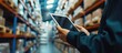 Worker hands holding tablet to checking stock on blurred warehouse background. AI generated image