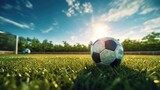 Fototapeta Sport - Soccer ball on the green field