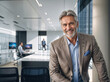 © Fabio Levy - portrait of a successful businessman consultant looking at camera and smiling inside modern office
