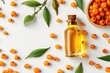 Top view of fresh berries and sea buckthorn oil on a white background
