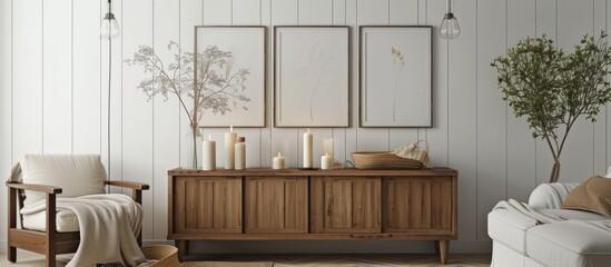 Poster - Simple living room interior with posters, candles on wooden cupboard, and white molding wall.