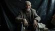 An elderly man sitting on a makeshift chair his legs amputated from injuries sustained in the war. His face bears the weight of all he has endured.