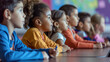 © Studio Light & Shade - Diverse group of multicultural children in the classroom, listening attentively. Kids wearing colorful clothes, sitting at the desk. Lesson at primary school. Attentive young students.
