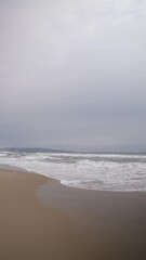 Poster - waves and sand stormy vertical video 4k