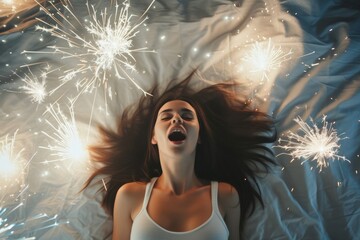 Euphoric Delight: Joyful Woman Surrounded by Sparklers on Blue