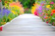 concrete path centerframe, blurry colorful flowers on both sides