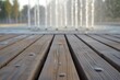 freshly swept wooden planks, with a softfocus water fountain behind