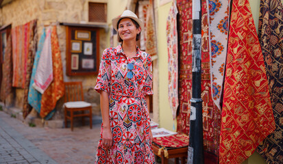 Canvas Print - female summer travel to Antalya, Turkey. young asian woman in red dress walk old town Kalechi , female tourist traveler discover interesting places and popular tourist attraction, look on capret