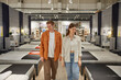 © Nomad_Soul - Young man and woman couple looking for new bed at modern furniture shop