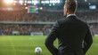 Back shot of coach (football) in suit
