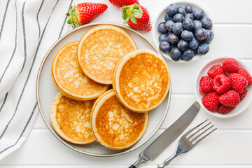 Poster - Homemade classic american pancakes with blueberries, raspberries and strawberries. Top view.