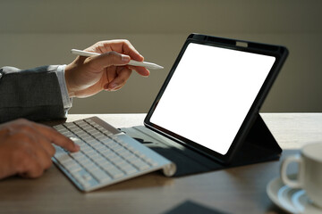 Poster - man holding blank screen tablet with isolated screen  at home.