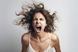 © Serhii - Close-up of a young woman angry, screaming in a scandal, white background isolate.