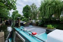 London - 29 05 2022: In The Foreground The Roof Of A Houseboat Moored On The Regent's Canal