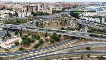 Top up aerial drone view of elevated road and traffic junctions in  metropolis city  during sunny day. Modern construction design of traffic ways to avoid traffic jams. Few vehicles