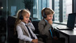Two children in a mock office setup, one pretending to be a manager with a headset, providing a fun twist to the corporate world